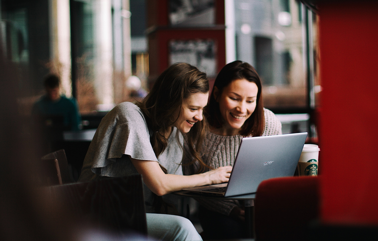 Consumers on a computer in a cafe