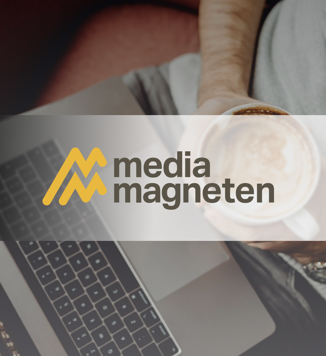 Mediamagneten's logo on a background image of a computer